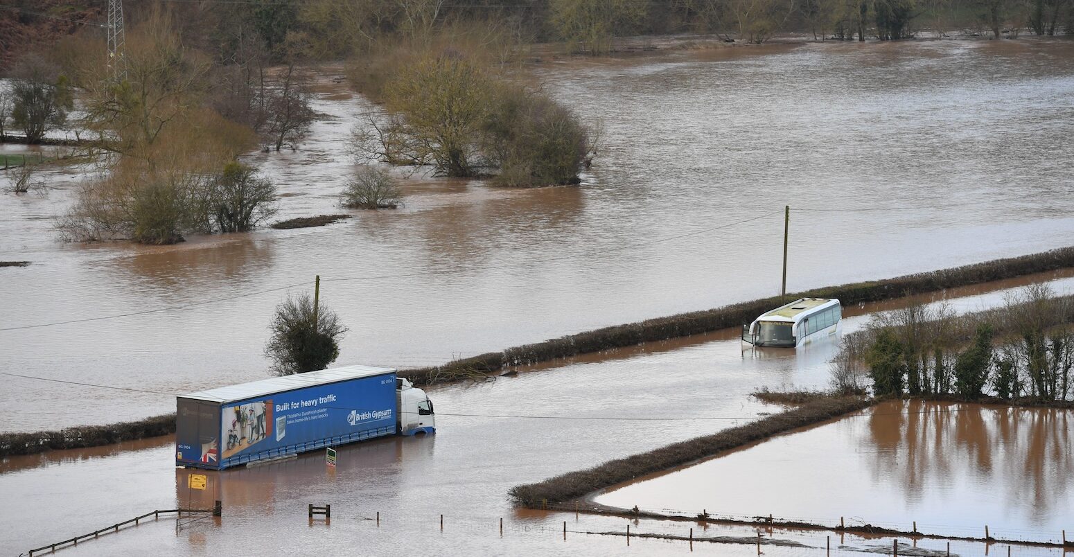 Large vehicles submerged in floodwater, Worcestershire, UK.