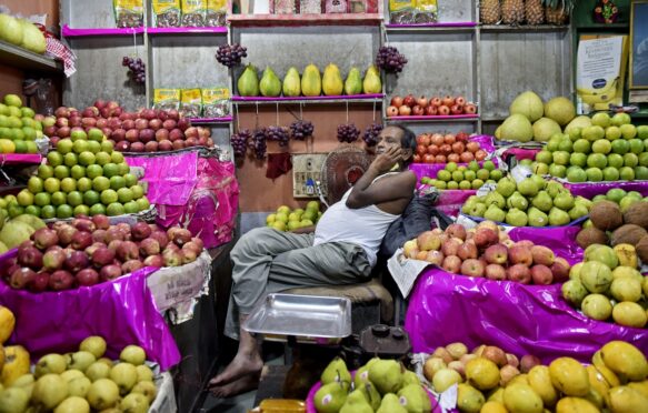 A fruit seller sleeps in his fruit shop in Kolkata, India.