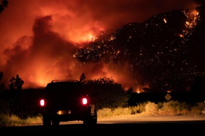 A wildfire burns on the side of the Trans-Canada Highway in British Columbia, Canada.