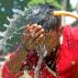 A person washes his face with water during high temperature weather day in Dhaka, Bangladesh, on April 11, 2023.