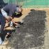 People check semi-processed biochar at a farm near Windhoek, Namibia.