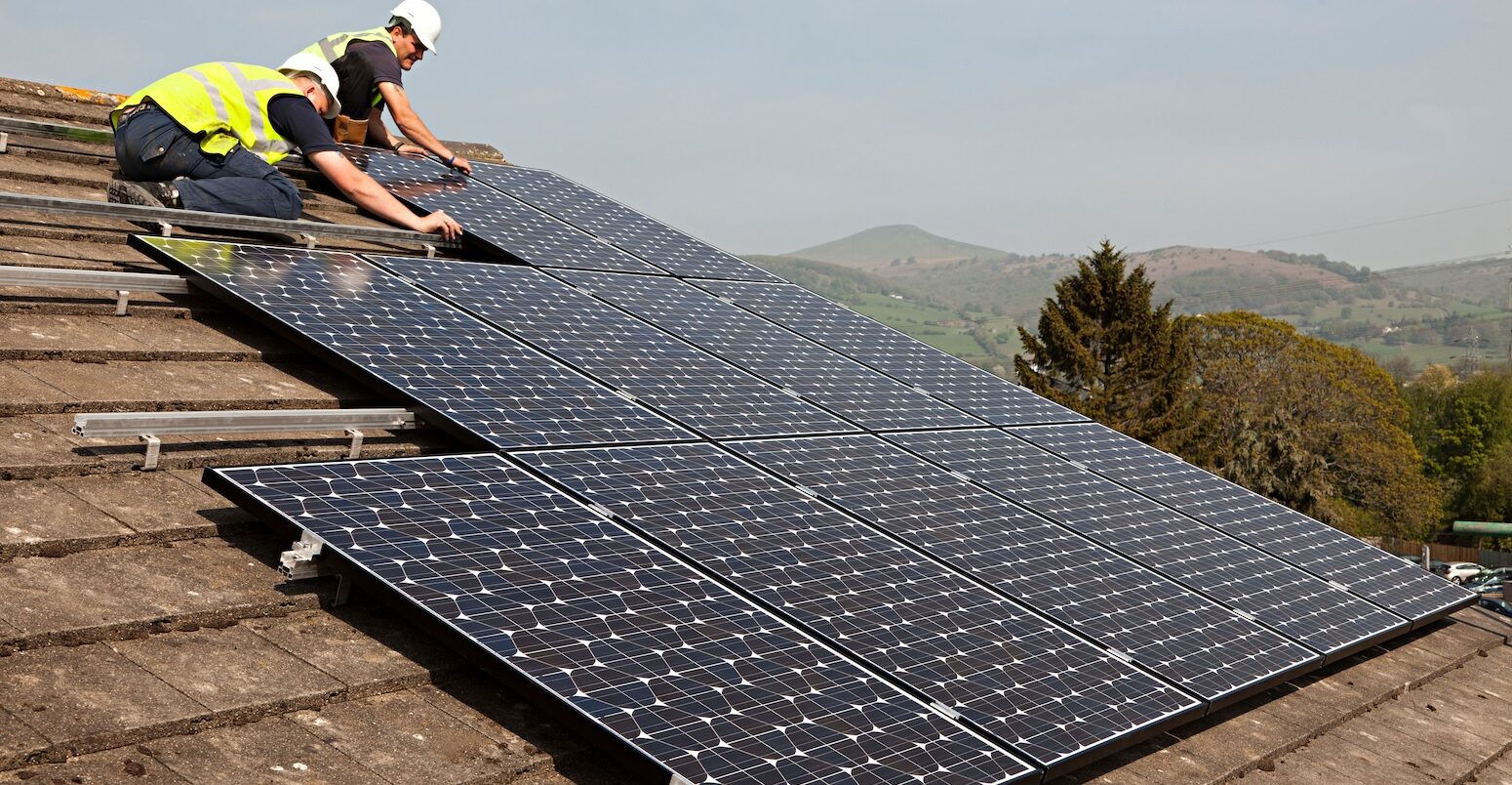 Fitting solar pv panels to house roof Wales UK.