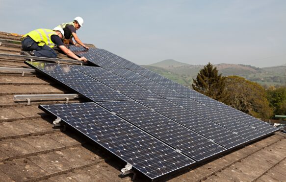 Fitting solar pv panels to house roof Wales UK.