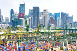 PSA International Brani Container Terminal with the CBD skyline, Brani Island, Singapore. Credit: Jason Knott / Alamy Stock Photo. FGRPBF