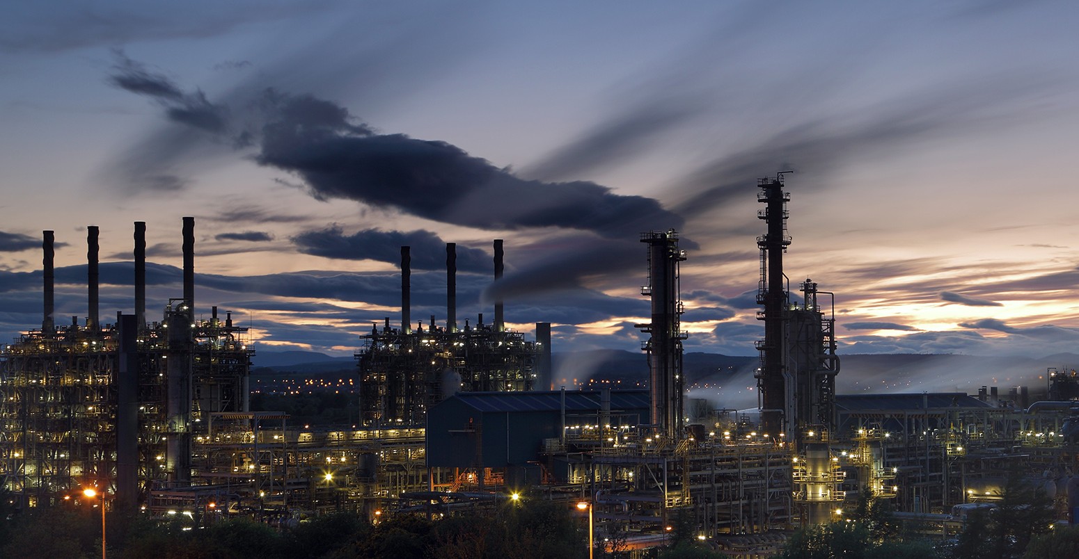 Illuminated natural gas processing plant at night, Scotland