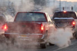 B7T95A Auto emissions- tailpipe exhaust from cars driving in town, waiting in traffic at an intersection. Image shot 2009. Exact date unknown.