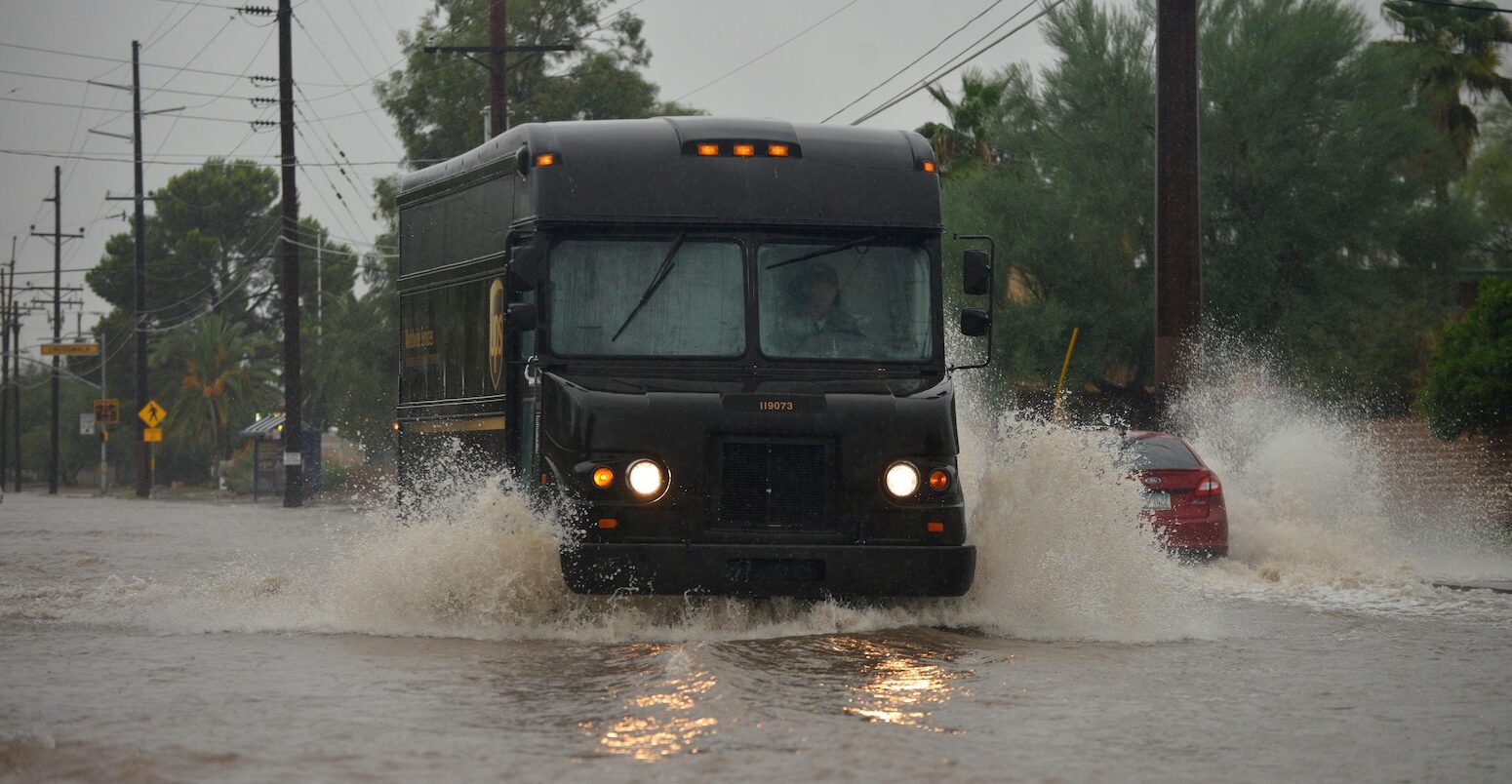 A delivery truck driving through flooded streets during a storm, Sonoran Desert, Arizona, USA. Credit: Norma Jean Gargasz / Alamy Stock Photo. Image ID: H28H7P