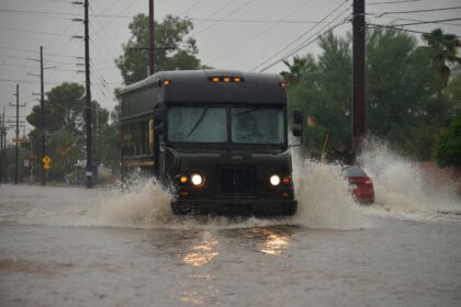 A delivery truck driving through flooded streets during a storm, Sonoran Desert, Arizona, USA. Credit: Norma Jean Gargasz / Alamy Stock Photo. Image ID: H28H7P