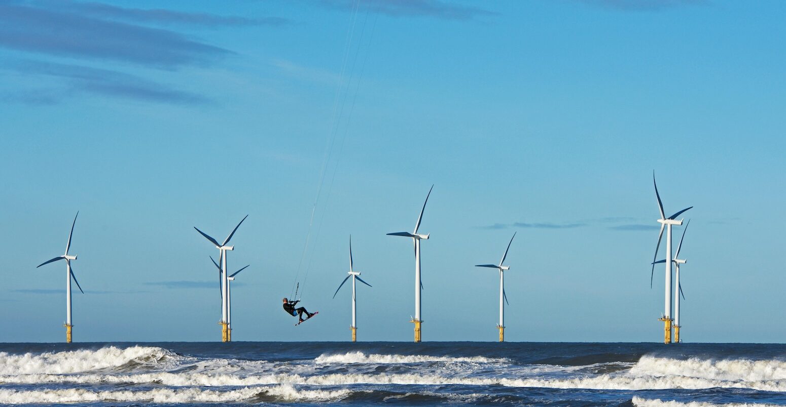 Offshore windfarm and kite surfer in Yorkshire, UK.