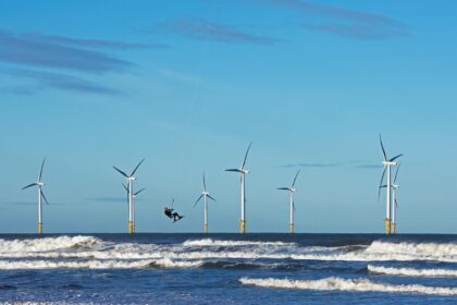 Offshore windfarm and kite surfer in Yorkshire, UK.