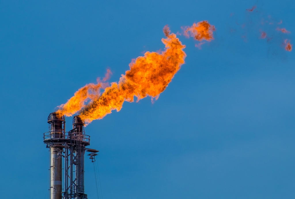 Flare stack at a petroleum refinery in Texas, US. Credit: Rex Wholster / Alamy Stock Photo. Image ID: M31J6P.