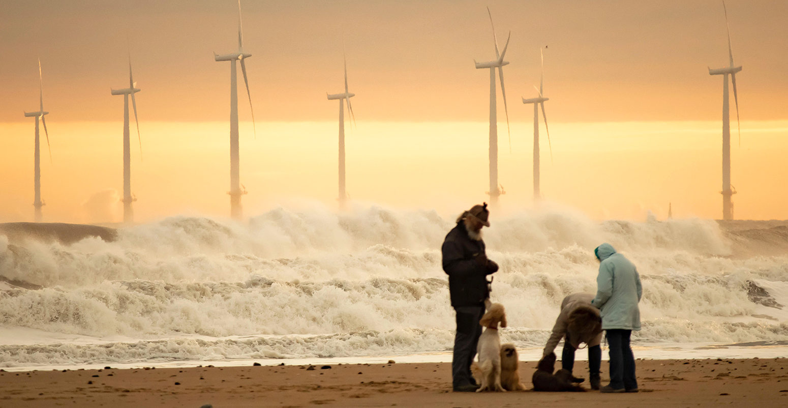 Offshore windfarm near Seaton Carew beach, County Durham, UK. Credit: Islandstock / Alamy Stock Photo. PYWFWF