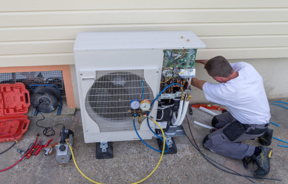 Plumber installing a heat pump.