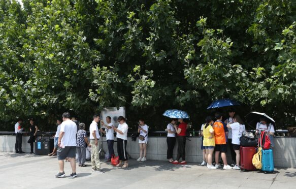 People seeking shade in Shanghai, China.