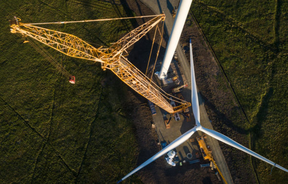 Wind turbine construction showing the propellor being prepared for lifting