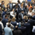 Delegates huddle during consultations on Paris Agreement Article 6.8.